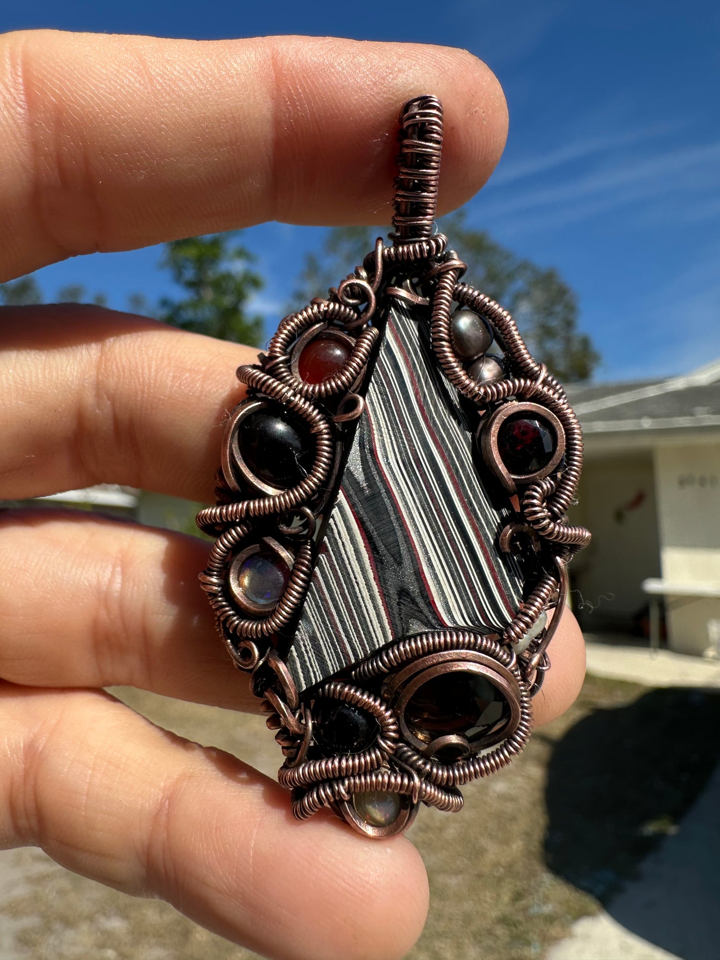 Swirly fordite copper pendant