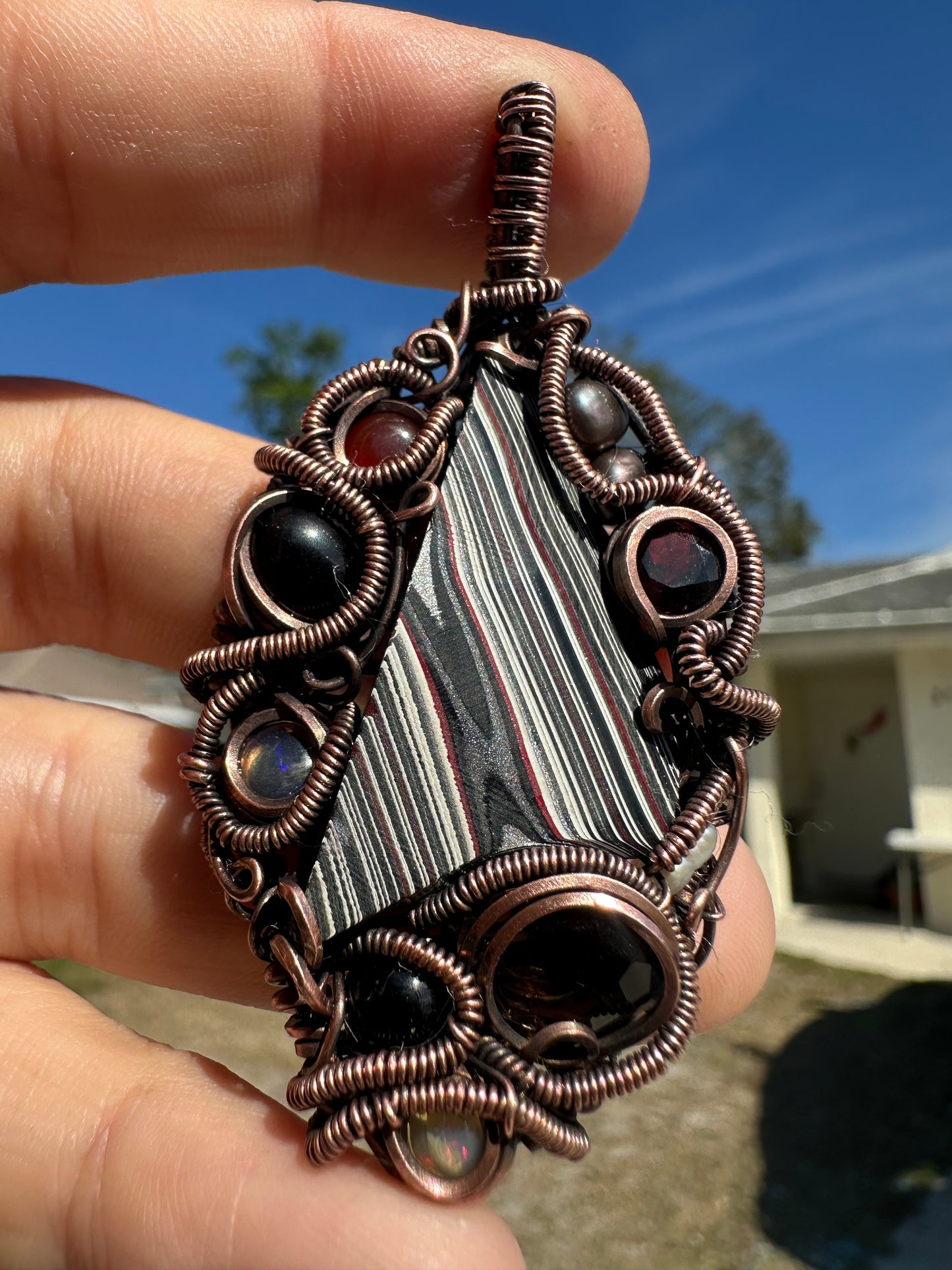 Swirly fordite copper pendant