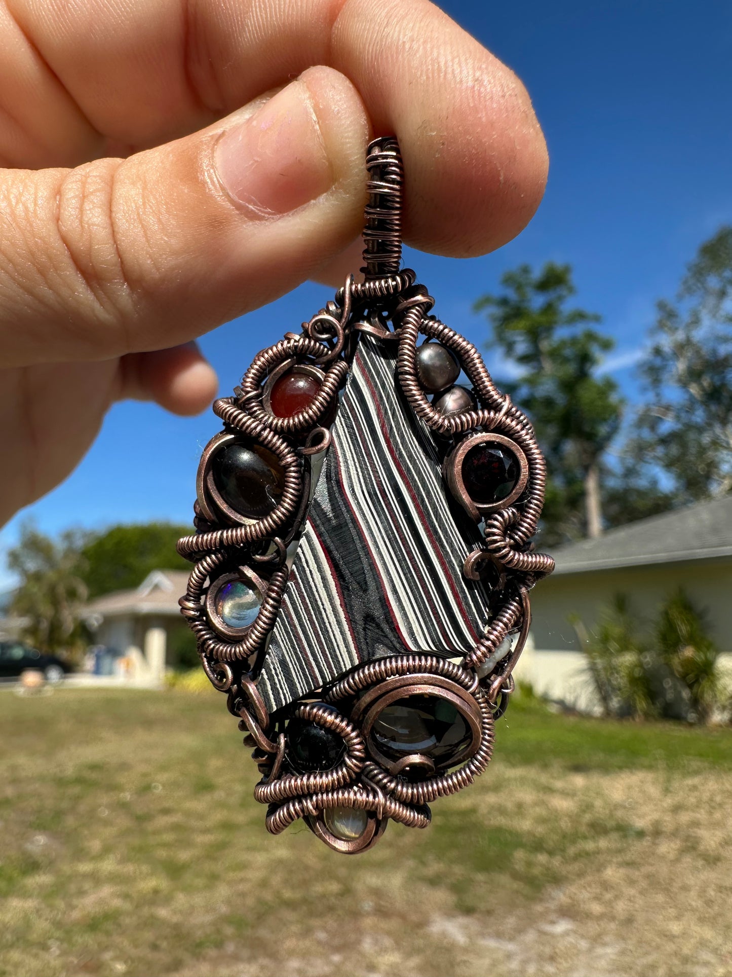 Swirly fordite copper pendant