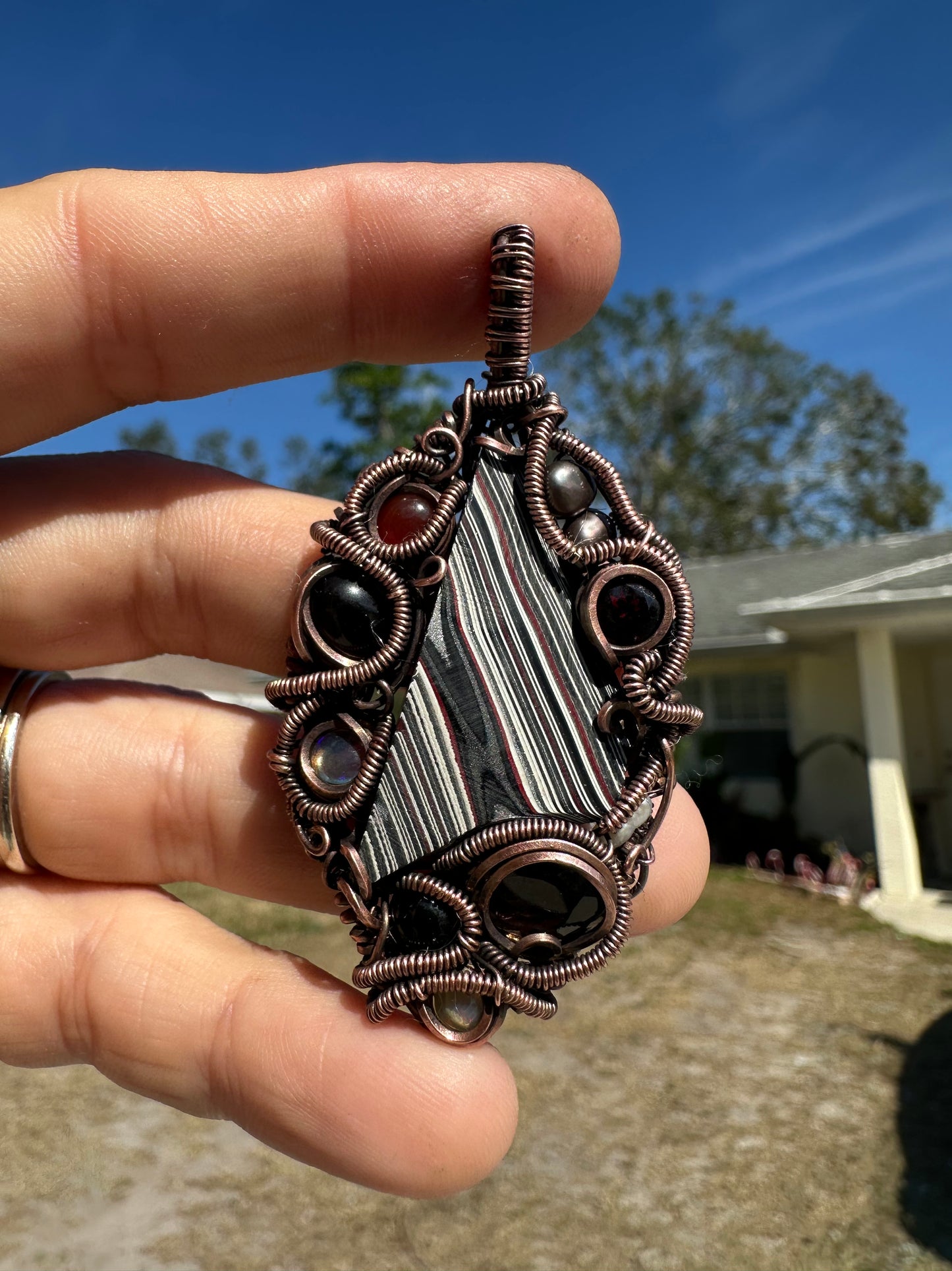 Swirly fordite copper pendant